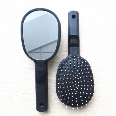 Double sided hairbrush with mirror on back